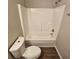 Well-maintained bathroom features a shower-tub combo, toilet, and modern fixtures with dark vinyl floors at 6500 Wellington Chase Ct, Lithonia, GA 30058