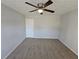 Spacious bedroom with neutral walls, plush carpet, and ceiling fan, providing a serene and comfortable space at 6500 Wellington Chase Ct, Lithonia, GA 30058