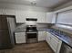 Modern kitchen with stainless steel appliances, granite countertops, and ample cabinet space at 6500 Wellington Chase Ct, Lithonia, GA 30058