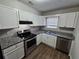 Stylish kitchen featuring granite counters, stainless steel appliances, and bright white cabinetry at 6500 Wellington Chase Ct, Lithonia, GA 30058