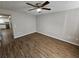 Open living room featuring new hardwood flooring and modern ceiling fan at 6500 Wellington Chase Ct, Lithonia, GA 30058