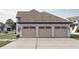 Three-car garage with light-colored wooden doors at 1276 A Rutledge Rd, Acworth, GA 30101
