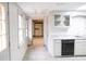 View of a galley-style basement kitchen with white cabinets and gray countertops at 2068 Lakewood Cir, Grayson, GA 30017