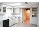 Basement kitchen with white cabinets, gray countertops, and black appliances at 2068 Lakewood Cir, Grayson, GA 30017