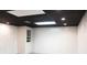 Finished basement room with white walls and black ceiling at 2068 Lakewood Cir, Grayson, GA 30017