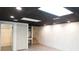 Finished basement with grey flooring, white brick, and a black ceiling at 2068 Lakewood Cir, Grayson, GA 30017