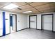 Bright basement room with gray flooring, closets, and access to bathroom at 2068 Lakewood Cir, Grayson, GA 30017
