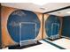 Basement room with dark blue walls, mural, mirror, and clothing racks at 2068 Lakewood Cir, Grayson, GA 30017