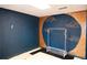 Basement room with dark blue walls, mural, and clothing rack at 2068 Lakewood Cir, Grayson, GA 30017