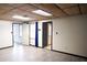 Large basement room with gray flooring and access to other rooms at 2068 Lakewood Cir, Grayson, GA 30017