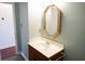 Simple bathroom with a vanity, mirror, and wood cabinet at 2068 Lakewood Cir, Grayson, GA 30017