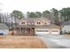 Two-story house with stone accents, porch, and attached garage at 2068 Lakewood Cir, Grayson, GA 30017