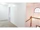 Upstairs hallway with carpet, neutral walls, and access to other rooms at 2068 Lakewood Cir, Grayson, GA 30017