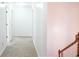 Long hallway with carpet and doors to bedrooms at 2068 Lakewood Cir, Grayson, GA 30017