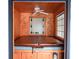 Indoor hot tub with wood paneling and stained glass window at 2068 Lakewood Cir, Grayson, GA 30017