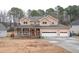 Two-story house with front porch and three-car garage at 2068 Lakewood Cir, Grayson, GA 30017