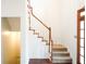 Elegant wooden staircase with carpeted steps and a simple railing at 2068 Lakewood Cir, Grayson, GA 30017