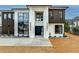 Modern home featuring a grand entrance with sleek black door, manicured garden, and architectural lighting at 15 Whitehead Rd, Sugar Hill, GA 30518