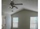 Bright bedroom with vaulted ceiling, ceiling fan, and two windows at 2388 Carousel Park Dr, Morrow, GA 30260