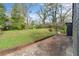 Large backyard with a gentle slope and mature trees providing shade and privacy at 951 Lawton Sw St, Atlanta, GA 30310