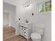 This bathroom has a modern vanity with storage, a toilet, and a window at 951 Lawton Sw St, Atlanta, GA 30310