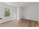 This bedroom has wood floors, white walls and a window that lets in natural light at 951 Lawton Sw St, Atlanta, GA 30310