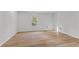 This bedroom features wood floors, a window letting in natural light and white walls at 951 Lawton Sw St, Atlanta, GA 30310