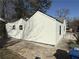 Rear corner of home with white siding, black framed windows and paved driveway at 951 Lawton Sw St, Atlanta, GA 30310