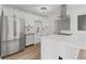 Beautiful kitchen features stainless appliances, white cabinetry and center island with seating at 951 Lawton Sw St, Atlanta, GA 30310