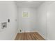Compact laundry room features laminate flooring, clean lines and a single window at 951 Lawton Sw St, Atlanta, GA 30310