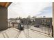 Balcony view overlooking upscale homes and street; features a black metal railing at 10931 Serenbe Ln, Chattahoochee Hills, GA 30268