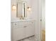 Elegant bathroom with marble countertops, gold accents, and custom cabinetry at 10931 Serenbe Ln, Chattahoochee Hills, GA 30268