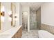 Luxurious main bathroom features double vanities, a soaking tub, and a separate glass-enclosed shower at 10931 Serenbe Ln, Chattahoochee Hills, GA 30268