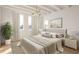 Bright main bedroom with a neutral color palette, large bed, decorative pillows, and natural light at 10931 Serenbe Ln, Chattahoochee Hills, GA 30268