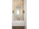Stylish powder room features a modern mirror, sconces, and a sleek floating vanity with quartz countertop at 10931 Serenbe Ln, Chattahoochee Hills, GA 30268