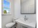 Half-bath with window, toilet, and modern sink at 3269 Durston Ct, Dacula, GA 30019