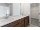 Elegant bathroom featuring double sinks, granite countertops, and wooden cabinets at 3269 Durston Ct, Dacula, GA 30019