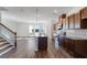 Open-concept kitchen with large island, stainless steel appliances, granite counters, and hardwood floors at 3269 Durston Ct, Dacula, GA 30019
