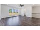 Bright living room with hardwood floors, ceiling fan, and large windows with natural light at 3269 Durston Ct, Dacula, GA 30019