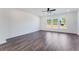 Bright living room with hardwood floors, ceiling fan, and large windows with natural light at 3269 Durston Ct, Dacula, GA 30019