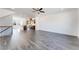 Open-concept living area with hardwood floors, ceiling fan, and staircase to upper level at 3269 Durston Ct, Dacula, GA 30019