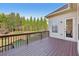 Back deck with wooden floors and railing features an outdoor view of the yard and tall trees at 2420 Bronze Ct, Cumming, GA 30041