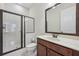 Bathroom featuring a glass-enclosed shower, single sink vanity, and modern fixtures for a clean aesthetic at 2420 Bronze Ct, Cumming, GA 30041