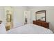 Inviting bedroom with plush bedding, dresser, and a glimpse into an en-suite bathroom for added convenience at 2420 Bronze Ct, Cumming, GA 30041