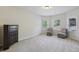 Cozy bedroom featuring neutral walls, carpet, two windows and a dark wood dresser at 2420 Bronze Ct, Cumming, GA 30041