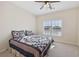 Cozy bedroom featuring a comfortable bed, ceiling fan, and a large window for ample sunlight at 2420 Bronze Ct, Cumming, GA 30041