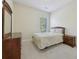 Comfortable bedroom with a plush bed, a dresser with a mirror, and a window for natural light at 2420 Bronze Ct, Cumming, GA 30041