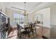 Bright dining room with hardwood floors, wainscoting, arched doorway, and large window at 2420 Bronze Ct, Cumming, GA 30041
