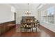 Formal dining room with coffered ceiling, wainscoting, hardwood floors, and large window at 2420 Bronze Ct, Cumming, GA 30041