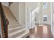 Elegant foyer with hardwood floors, a staircase, and natural light pouring in from the front door at 2420 Bronze Ct, Cumming, GA 30041